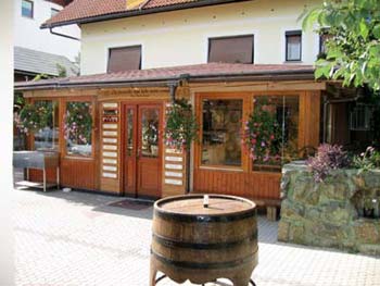 Golden organic honey flowing from a wooden dipper in a pristine Slovenian meadow